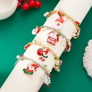 Christmas charm bracelet with Santa Claus, elk, and snowflakes on a green holiday backdrop