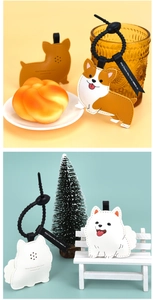 Detail of cartoon leather dog charms Corgi and Samoyed with black lanyards and ribbons