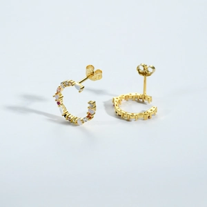 Macro view of S925 sterling silver C-shaped earrings with colorful gemstone inlay
