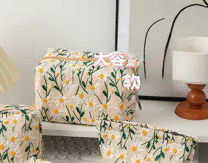 Detail of white daisy embroidery on cream canvas makeup bag with large capacity
