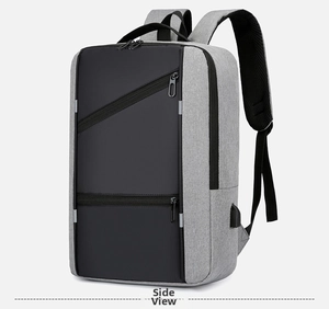 Detail of grey business laptop backpack featuring side USB charging port and zipper pockets