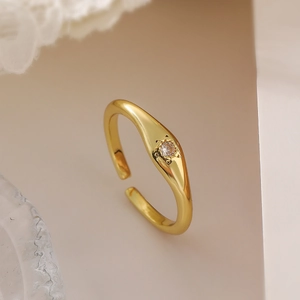 Detailed view of an 18K gold plated minimalist open ring with a sparkling clear zircon stone