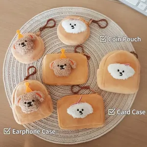 Cute plush puppy coin purses, card holders and earphone cases on a woven mat