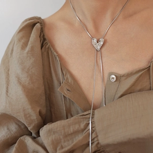 Detail of silver liquid metal heart pendant on long chain with adjustable slider