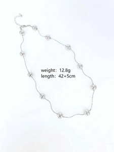 Detailed view of silver beads necklace with star engravings and length measurements