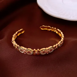 Vintage 18k gold plated enamel flower cuff bangle with intricate floral cutouts and stones