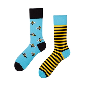 Detail view of cotton crew socks featuring mismatched bee patterns and yellow stripes