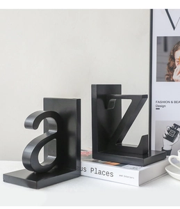 Detail of minimalist black metal bookends featuring lowercase 'a' and uppercase 'Z' letters