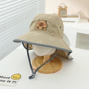 Detail of children's khaki sun hat featuring cute cartoon capybara patch and windproof cord