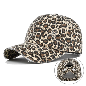 Detail of leopard print ponytail baseball cap featuring vintage distressed fabric and cross straps