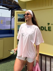 Pink oversize drop shoulder cotton T-shirt for women in a vibrant outdoor summer setting