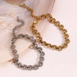 14K gold plated and silver chunky chain bracelets set on a textured white shell surface
