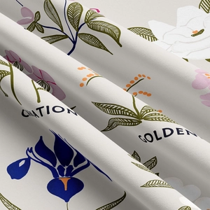 Close-up of fabric texture showing colorful floral carnation patterns on white tapestry