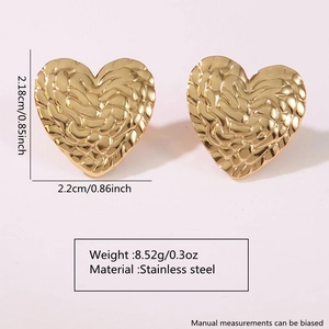 Detail view of heart-shaped stainless steel earrings with textured gold finish and size dimensions