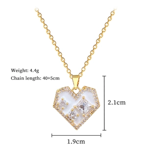 Detail view of gold heart pendant with cubic zirconia crystals and size measurements