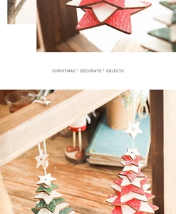 Detailed close-up of colorful wooden star-shaped Christmas ornaments with warm festive lighting
