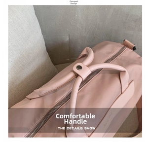 Detail of pink fitness bag featuring durable nylon handles and premium metal snap buttons