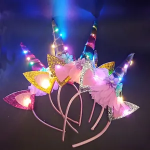 Detail of LED unicorn headband with sequin ears and colorful flowers for party glow