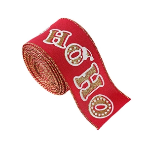 Red Christmas ribbon roll with gold HO HO lettering and white snow patterns for holiday decor
