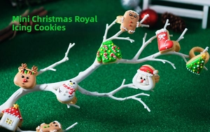 Detailed view of eight festive Royal Icing Christmas cookies on white decorative branches