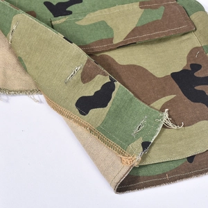 Detailed macro view of the camouflage vest showing fabric texture and reinforced stitching