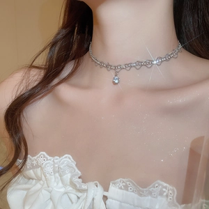 Macro shot of silver-tone sparkling zircon wavy choker with a brilliant round pendant