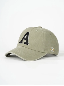 Detailed embroidery of letter A on light olive green washed cotton baseball cap