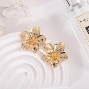 Elegant gold flower stud earrings with brushed metal texture and minimalist five-petal design