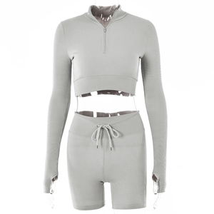Close-up of light gray ribbed two-piece set with half-zip top and drawstring shorts