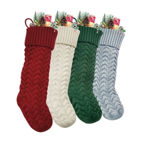 Set of four knitted Christmas stockings in red, white, green and blue with pine cone decor