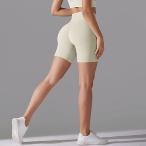 Detail view of seamless high-waisted yoga shorts in beige with a supportive wide waistband