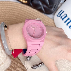 Pink quartz watch with polygonal case on model's wrist with fashion accessories
