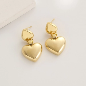 Elegant 24K gold plated stacked heart stud earrings on a minimalist white background