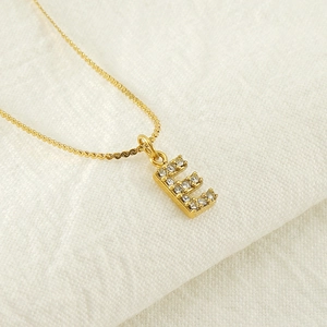 Gold plated stainless steel letter E necklace with diamonds on minimalist chain