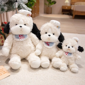 Three plush teddy puppy toys in varied sizes with red plaid bibs on a cozy carpet