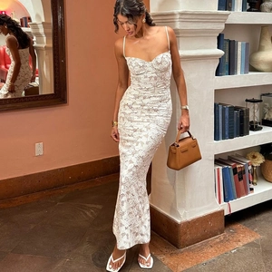 Close-up of white lace slip dress with crisscross back ties on a professional fashion model