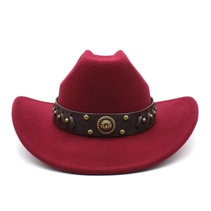 Detailed view of wine red western cowboy hat with studded leather band and vintage plaque