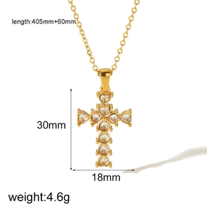 Detail view of gold cross pendant with cubic zirconia heart settings and size specifications