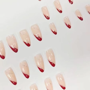 Long almond press-on nails with pink base, wine red glitter French tips, and star motifs