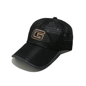 Macro detail of breathable mesh baseball cap with embroidered letter G and grey visor trim