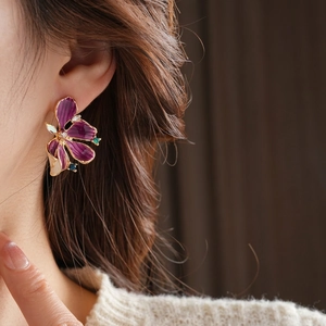 Vintage Blumenohrstecker mit lila Emaille-Blütenblättern und Kristallakzenten am Model