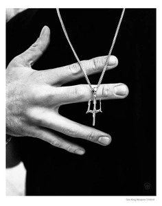 Detailed macro view of the silver Sea King Trident pendant necklace with sleek metal finish