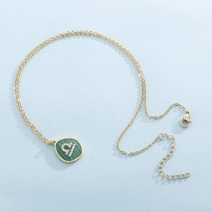 Gold Libra constellation necklace with green malachite inlay and sparkling crystals
