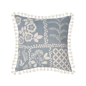 Blue cotton linen throw pillow cover with white floral pattern and tassel edges