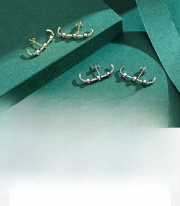 Macro detail of S925 silver earrings with 5A multi-colored zircon stones and gold plating