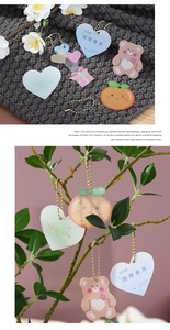 Detail of acrylic wedding gift tags featuring bear and heart shapes with hanging rope