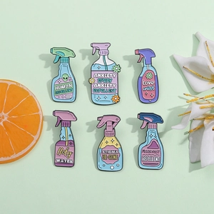 Set of 6 colorful enamel bottle pins with creative text labels and flower designs
