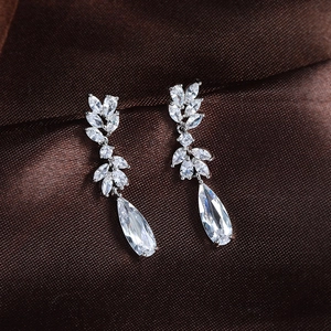 Elegant silver drop earrings with marquise and teardrop zircon crystals on satin fabric