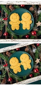 Gingerbread man cookies in a green ceramic plate with festive Christmas decorations