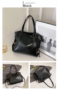 Detail of black glossy tote bag with gold ring hardware and detachable shoulder strap